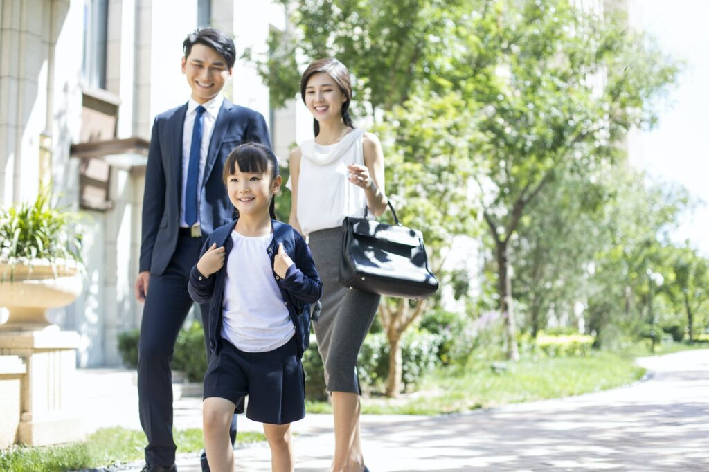 Parents taking their child to school in the morning